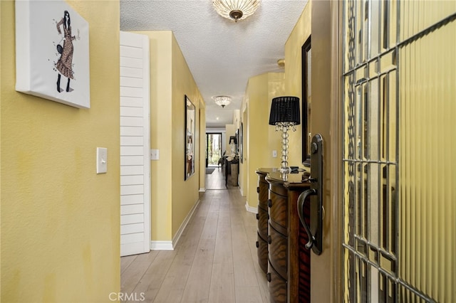 76022 Honeysuckle Dr, Palm Desert, CA 92211 - corridor with wood finished floors and a textured ceiling