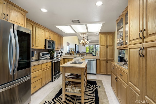 76022 Honeysuckle Dr, Palm Desert, CA 92211 - kitchen featuring appliances with stainless steel finishes, a chandelier, glass insert cabinets, light wood-style flooring, and recessed lighting