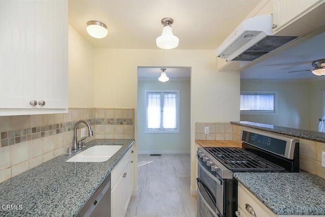 3115 Evelyn St, La Crescenta, CA 91214 - kitchen with appliances with stainless steel finishes, a sink, light stone countertops, and white cabinets