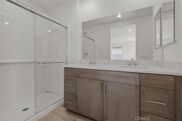 16017 E Preserve Loop, Chino, CA 91708 - full bathroom featuring double vanity, a shower stall, wood finished floors, and recessed lighting