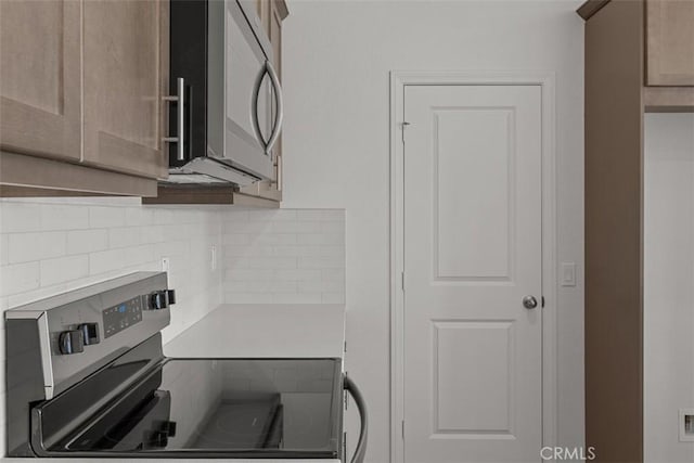 16017 E Preserve Loop, Chino, CA 91708 - kitchen featuring stainless steel appliances, tasteful backsplash, and light countertops
