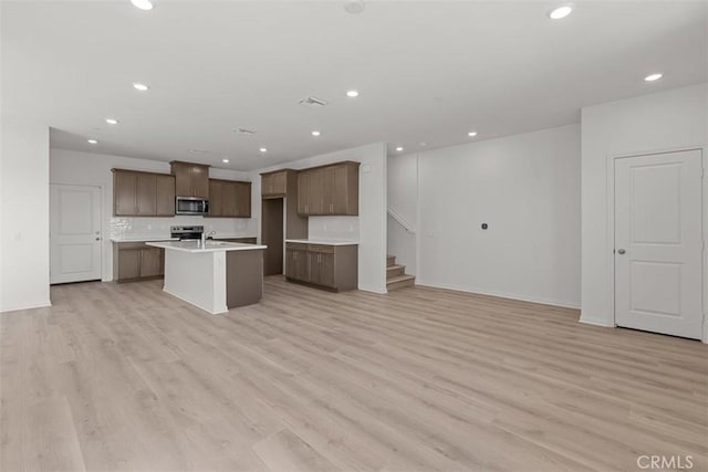 16017 E Preserve Loop, Chino, CA 91708 - kitchen with stainless steel appliances, open floor plan, recessed lighting, a center island with sink, and light countertops