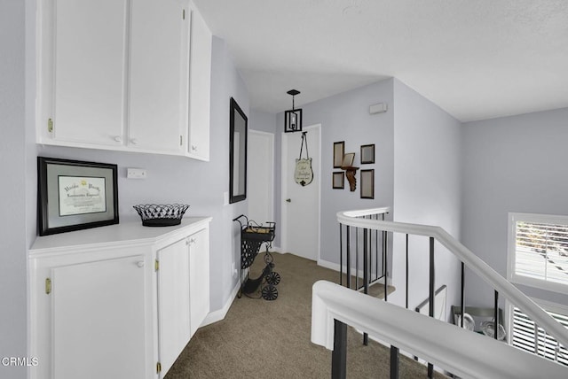 885 Oakland Hills Dr, Banning, CA 92220 - corridor with an upstairs landing, carpet floors, and baseboards