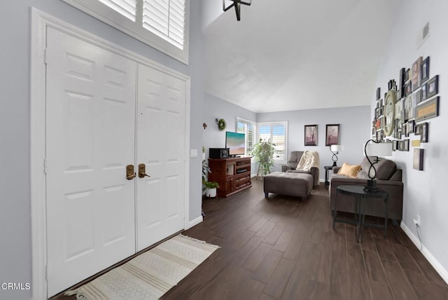 885 Oakland Hills Dr, Banning, CA 92220 - foyer with dark wood-style flooring, high vaulted ceiling, and baseboards