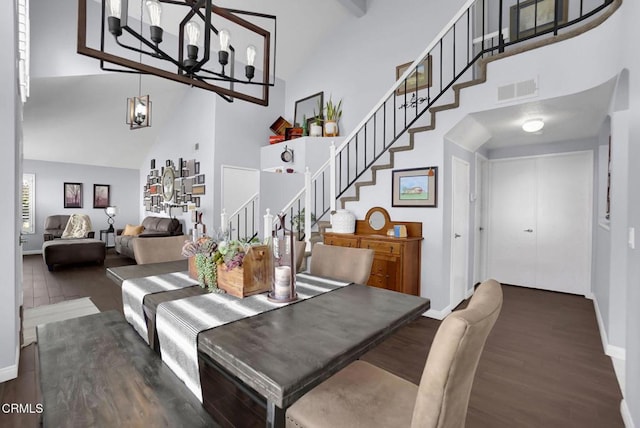 885 Oakland Hills Dr, Banning, CA 92220 - dining area featuring high vaulted ceiling, baseboards, wood finished floors, stairway, and a chandelier