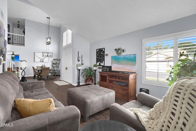 885 Oakland Hills Dr, Banning, CA 92220 - living room with wood finished floors, baseboards, high vaulted ceiling, and stairway