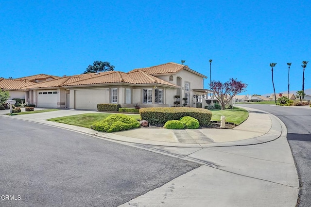 885 Oakland Hills Dr, Banning, CA 92220 - mediterranean / spanish-style home featuring a garage, a tiled roof, stucco siding, and driveway