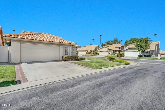 885 Oakland Hills Dr, Banning, CA 92220 - view of front of property featuring a tile roof, stucco siding, a residential view, driveway, and an attached garage
