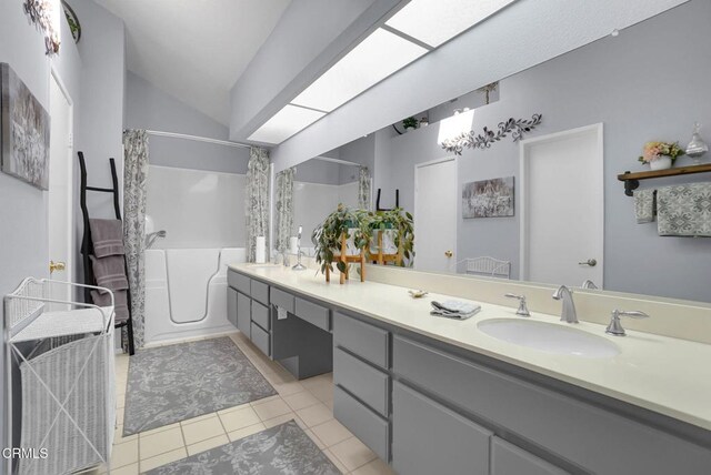 885 Oakland Hills Dr, Banning, CA 92220 - bathroom with double vanity, tile patterned floors, and vaulted ceiling