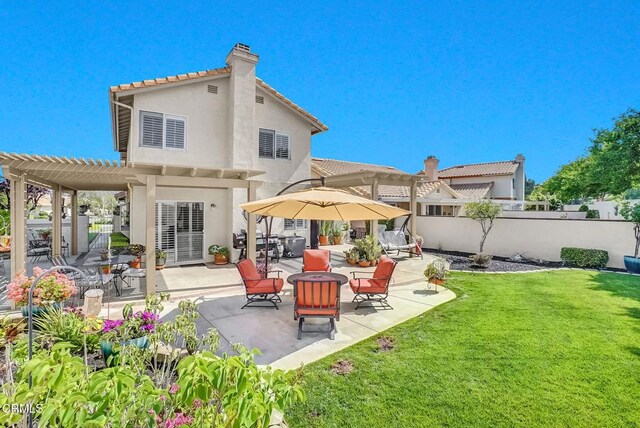 885 Oakland Hills Dr, Banning, CA 92220 - rear view of property featuring a pergola, stucco siding, a patio, a tiled roof, and a chimney