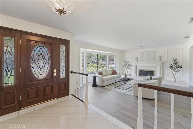 1130 Hidden Springs Ln, Glendora, CA 91741 - entryway featuring a glass covered fireplace and ornamental molding