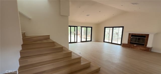 33710 Santiago Rd, Acton, CA 93510 - stairway featuring wood finished floors, high vaulted ceiling, and a fireplace