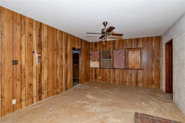62853 Desert Trail Dr, Joshua Tree, CA 92252 - spare room featuring ceiling fan, wood walls, and a textured ceiling