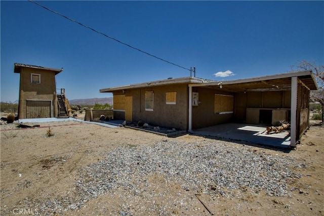 62853 Desert Trail Dr, Joshua Tree, CA 92252 - back of property featuring stairs and a patio