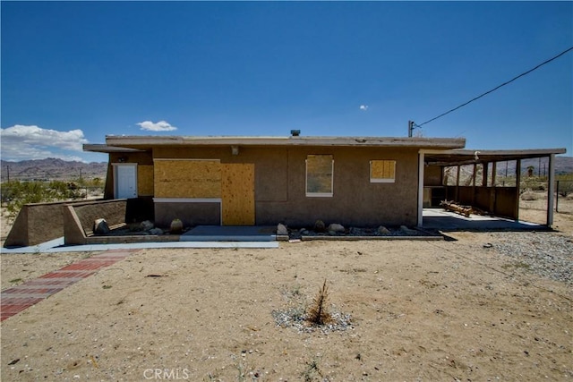 62853 Desert Trail Dr, Joshua Tree, CA 92252 - back of house featuring stucco siding