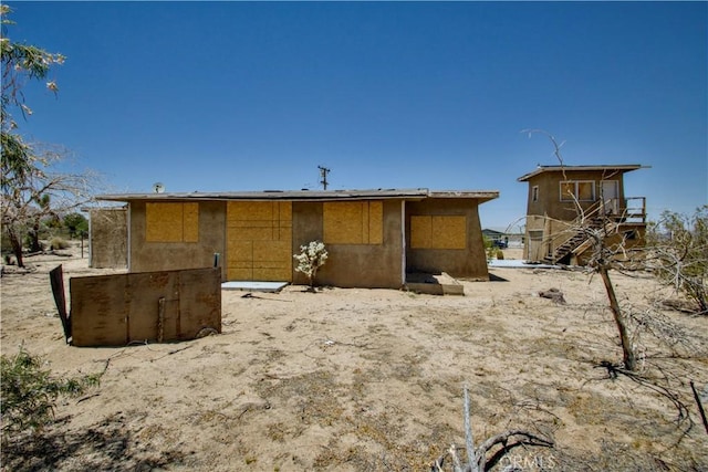 62853 Desert Trail Dr, Joshua Tree, CA 92252 - back of house featuring stairs