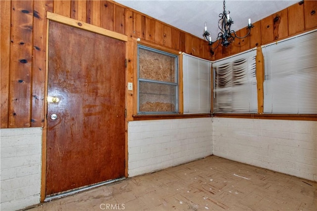 62853 Desert Trail Dr, Joshua Tree, CA 92252 - spare room featuring a chandelier and concrete block wall