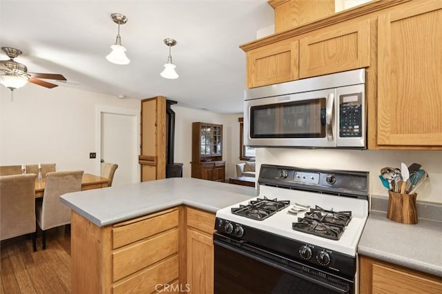 6950 Navarette Ave, Atascadero, CA 93422 - kitchen with range with gas cooktop, stainless steel microwave, a ceiling fan, and light countertops
