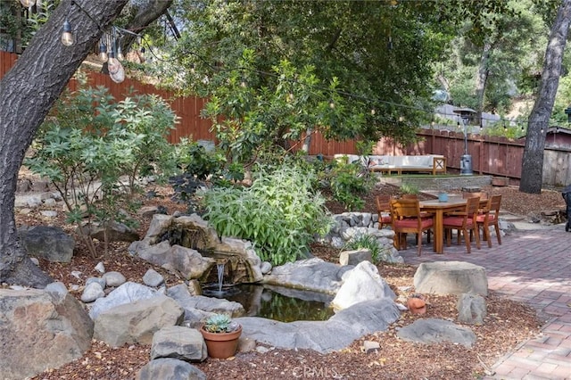 6950 Navarette Ave, Atascadero, CA 93422 - view of yard featuring a patio area, outdoor dining area, and a garden pond