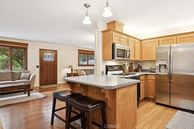 6950 Navarette Ave, Atascadero, CA 93422 - kitchen featuring appliances with stainless steel finishes, open floor plan, light countertops, and a breakfast bar area