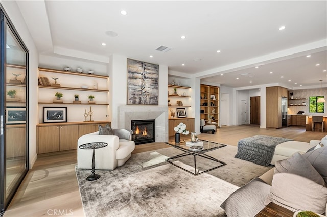 20215 Lorenzana Dr, Woodland Hills, CA 91364 - living room featuring light wood-type flooring, a high end fireplace, and recessed lighting