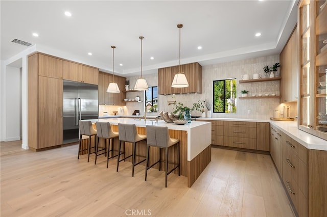 20215 Lorenzana Dr, Woodland Hills, CA 91364 - kitchen with open shelves, built in fridge, light wood-style flooring, modern cabinets, and recessed lighting