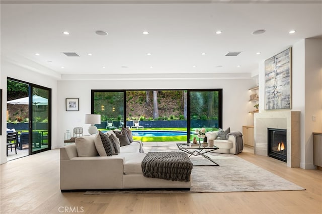 20215 Lorenzana Dr, Woodland Hills, CA 91364 - living room featuring healthy amount of natural light, light wood-style flooring, a fireplace, and recessed lighting