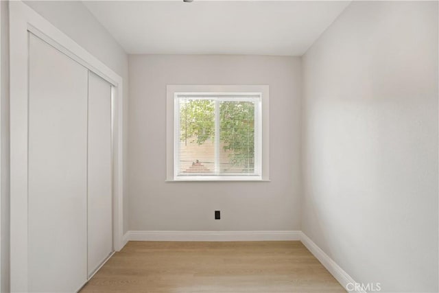 605 E Fredricks St, Barstow, CA 92311 - unfurnished bedroom with light wood-style floors, a closet, and baseboards