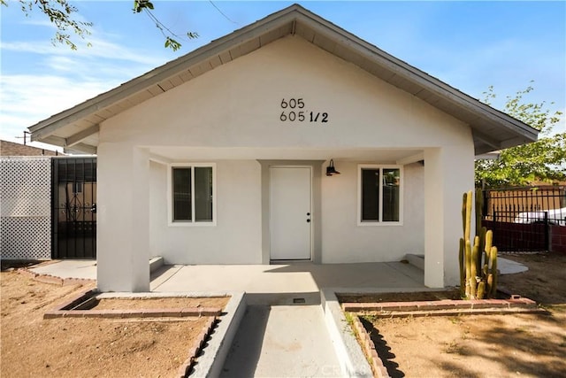 605 E Fredricks St, Barstow, CA 92311 - view of exterior entry with stucco siding and a patio