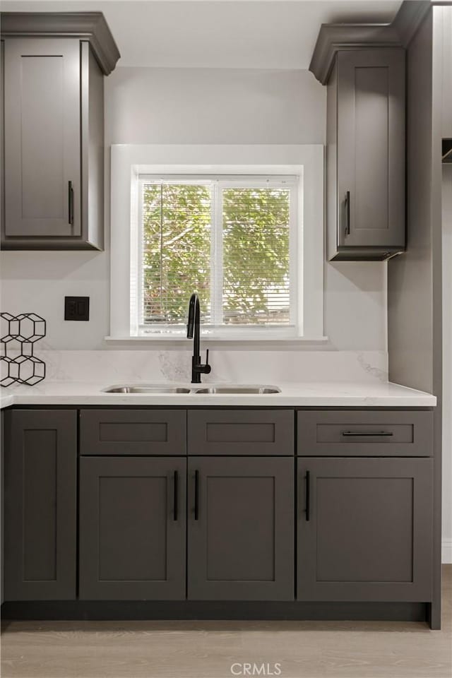 605 E Fredricks St, Barstow, CA 92311 - kitchen featuring a sink, gray cabinets, light countertops, and light wood-style floors
