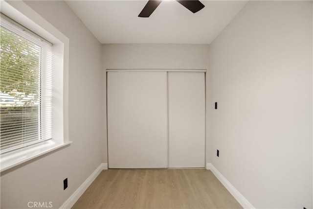605 E Fredricks St, Barstow, CA 92311 - unfurnished bedroom featuring light wood finished floors, a closet, baseboards, and a ceiling fan
