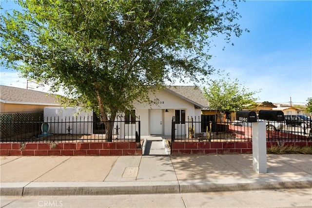 605 E Fredricks St, Barstow, CA 92311 - view of front of house featuring stucco siding, a fenced front yard, and a gate