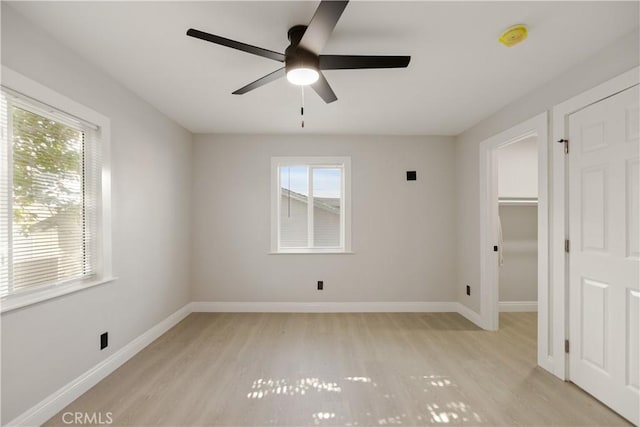 605 E Fredricks St, Barstow, CA 92311 - unfurnished bedroom with light wood-style floors, baseboards, a walk in closet, and a ceiling fan