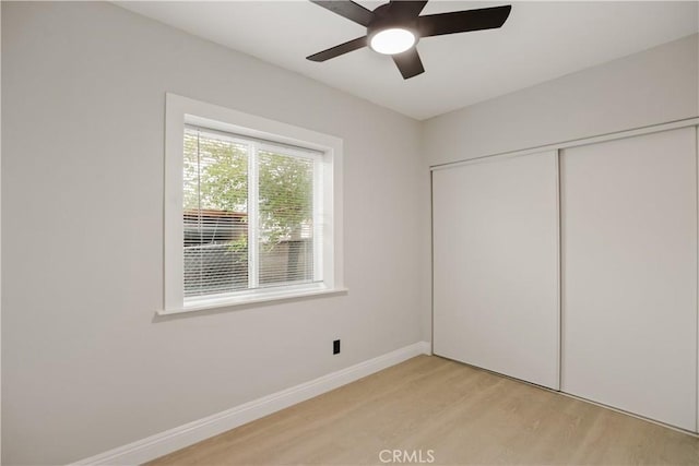 605 E Fredricks St, Barstow, CA 92311 - unfurnished bedroom with light wood-type flooring, a closet, baseboards, and a ceiling fan
