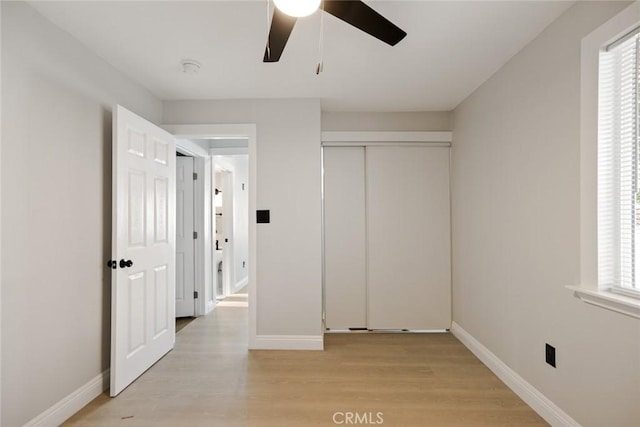 605 E Fredricks St, Barstow, CA 92311 - unfurnished bedroom featuring light wood-style floors, baseboards, a closet, and a ceiling fan