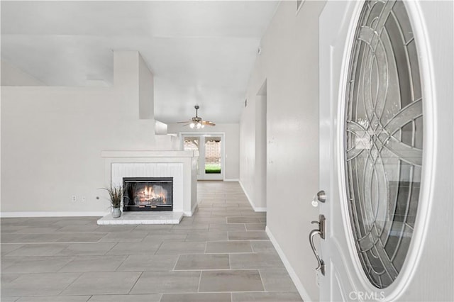 45634 Berkshire St, Lancaster, CA 93534 - foyer entrance with a fireplace, a ceiling fan, baseboards, and vaulted ceiling