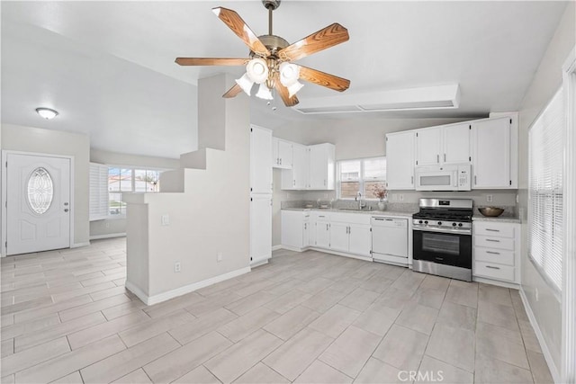 45634 Berkshire St, Lancaster, CA 93534 - kitchen with white appliances, lofted ceiling, light countertops, plenty of natural light, and white cabinets