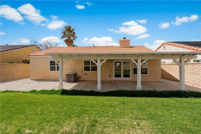 45634 Berkshire St, Lancaster, CA 93534 - back of house with central AC unit, a chimney, stucco siding, and a tile roof