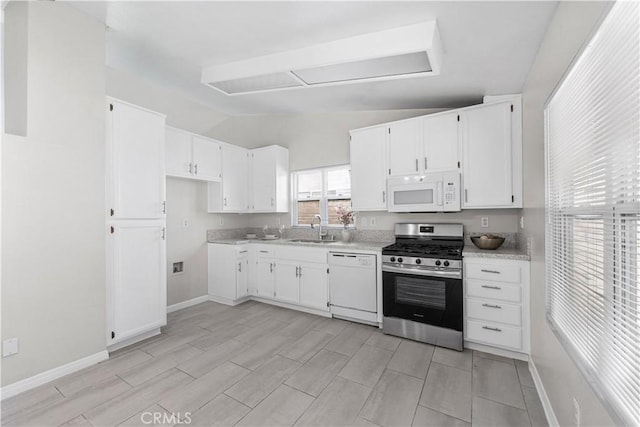 45634 Berkshire St, Lancaster, CA 93534 - kitchen with white appliances, a sink, lofted ceiling, white cabinetry, and light countertops