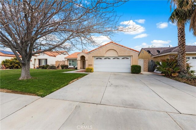 45634 Berkshire St, Lancaster, CA 93534 - view of front of house with an attached garage, stucco siding, driveway, and a front yard