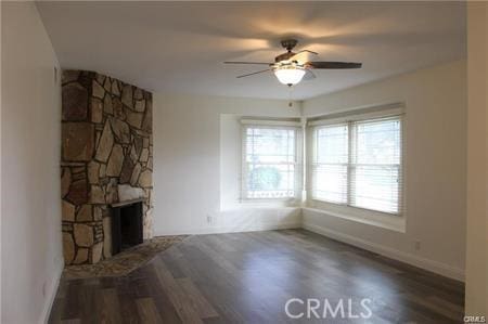 1679 N 2nd Ave, Upland, CA 91784 - unfurnished living room featuring ceiling fan, wood finished floors, and a stone fireplace