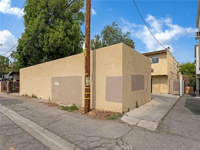 7049 Vassar Ave, Canoga Park, CA 91303 - view of property exterior with a gate and stucco siding