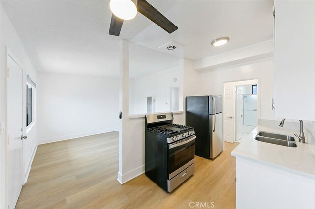 1242 Cedar Ave, Long Beach, CA 90813 - kitchen featuring stainless steel appliances, a sink, light wood-style flooring, light countertops, and ceiling fan