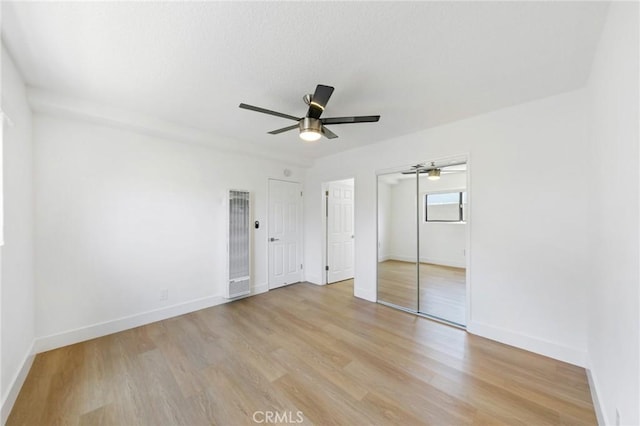 1242 Cedar Ave, Long Beach, CA 90813 - unfurnished bedroom with a heating unit, light wood-style flooring, and baseboards
