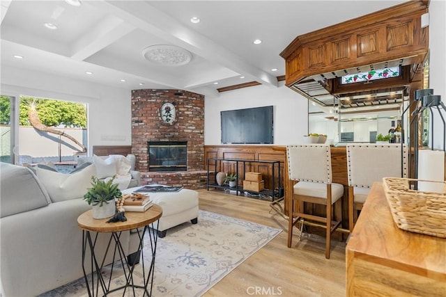 5144 Meadow Wood Ave, Lakewood, CA 90712 - living room featuring light wood-type flooring, beamed ceiling, recessed lighting, and a brick fireplace