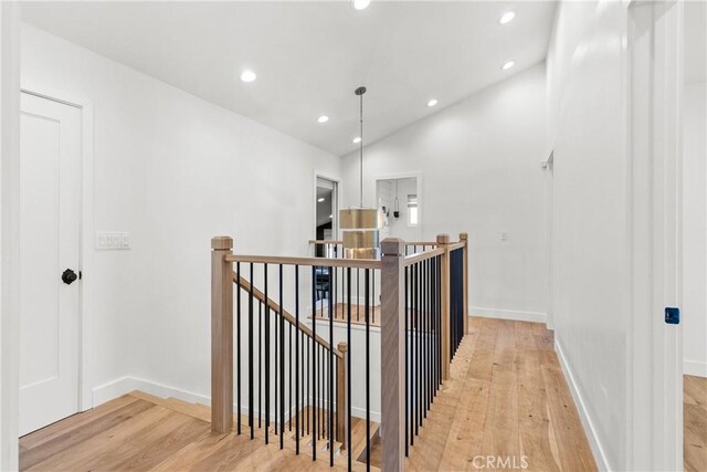 5144 Meadow Wood Ave, Lakewood, CA 90712 - corridor with an upstairs landing, light wood-style flooring, recessed lighting, and lofted ceiling