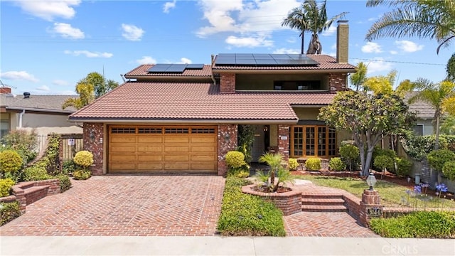 5144 Meadow Wood Ave, Lakewood, CA 90712 - view of front of home featuring a tiled roof, roof mounted solar panels, and decorative driveway