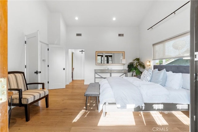 5144 Meadow Wood Ave, Lakewood, CA 90712 - bedroom featuring a towering ceiling, light wood-style floors, and recessed lighting