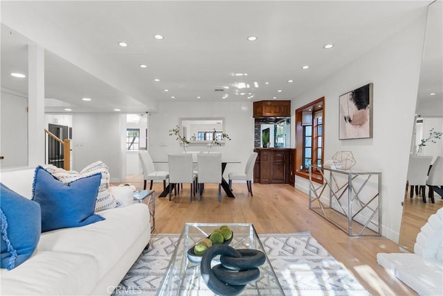 5144 Meadow Wood Ave, Lakewood, CA 90712 - living room featuring recessed lighting, light wood-style floors, and stairway