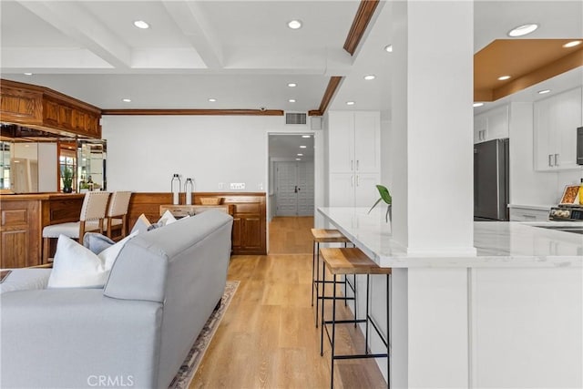5144 Meadow Wood Ave, Lakewood, CA 90712 - living area with light wood-style floors, beamed ceiling, recessed lighting, and bar area